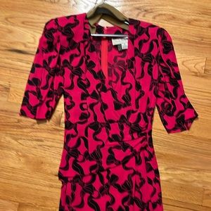 Nicole Miller dress.  Pink with black bow pattern.  Faux wrap.  - size 6